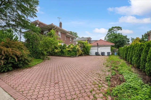 a pathway of a house with a yard