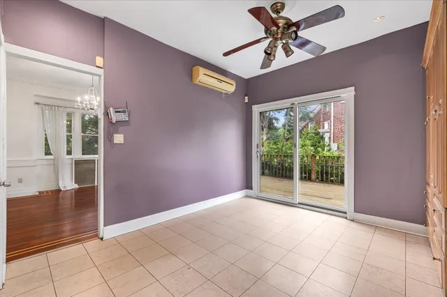 a view of a livingroom with a chandelier fan and windows