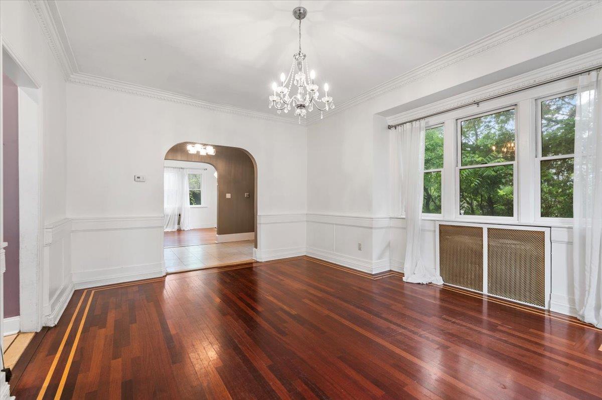 345 Broadway Lawrence, NY 11559 - Photo 8 of 25 a view of empty room with wooden floor and fan