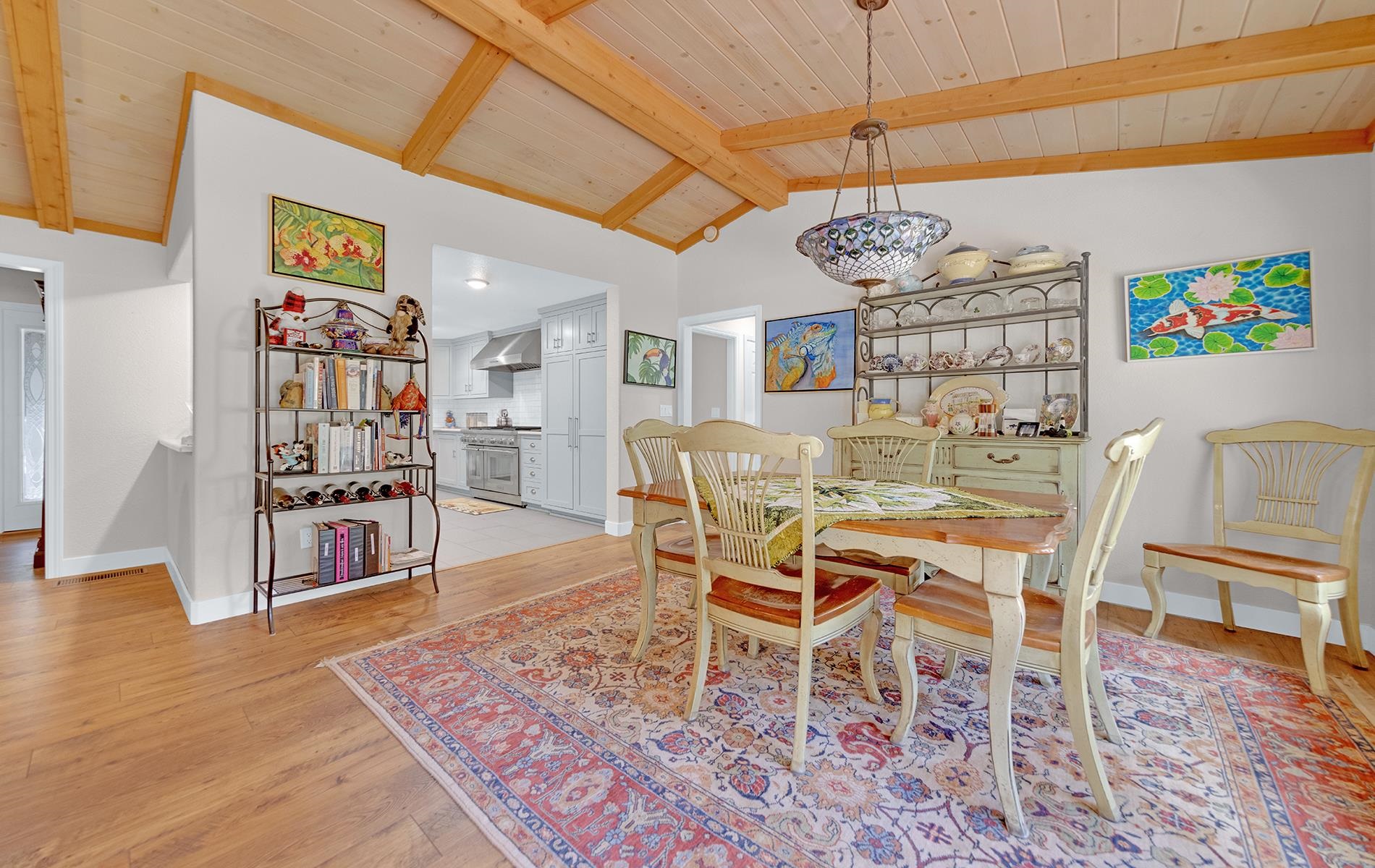 650 Wagon Road Chester, CA 96020 - Photo 5 of 36 a dining room with wooden floor a chandelier a wooden table and chairs