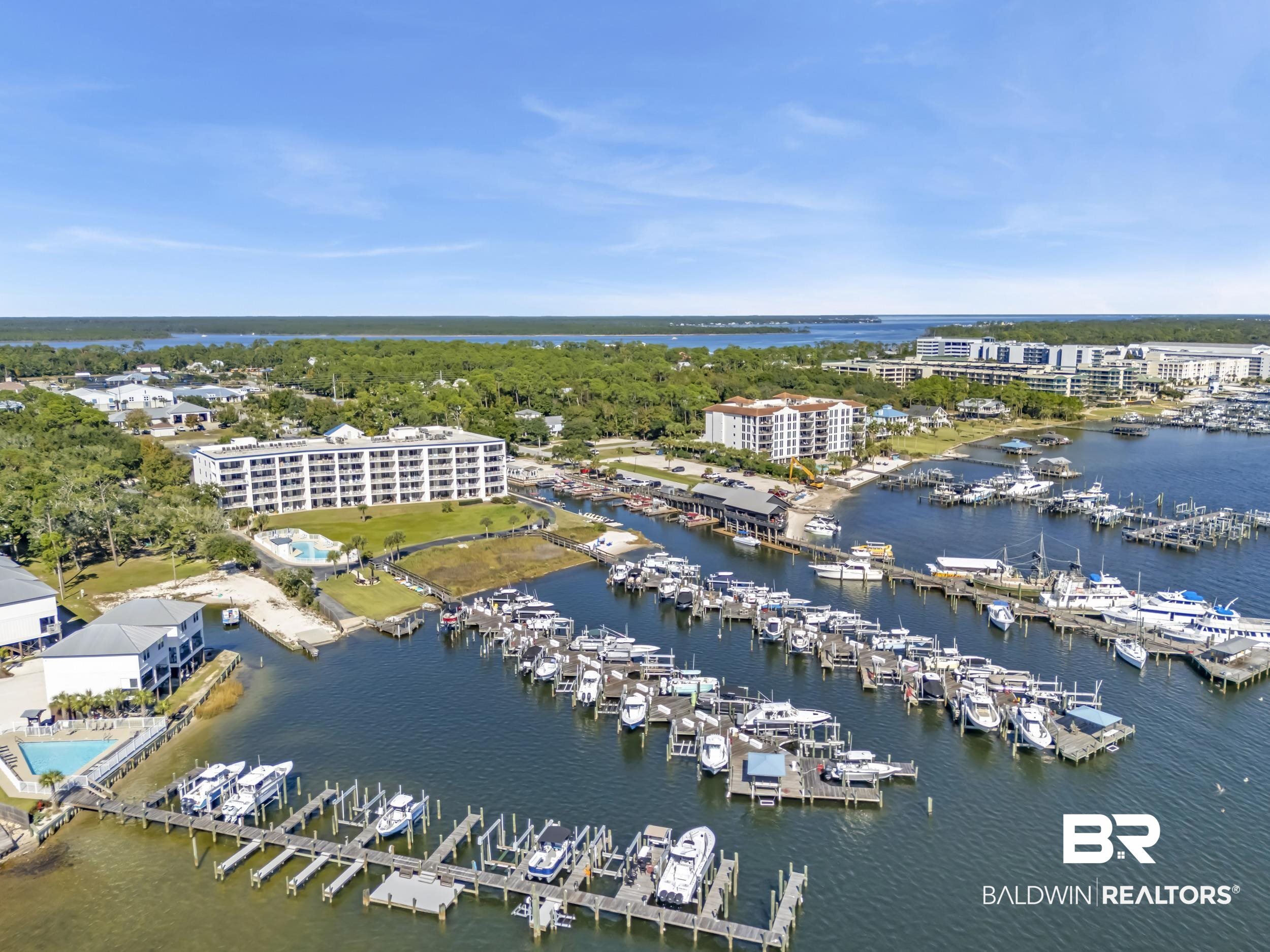 27282 Canal Road, Unit 104 Orange Beach, AL 36561 - Photo 9 of 79 Bird's eye view of a marina and a nearby body of water