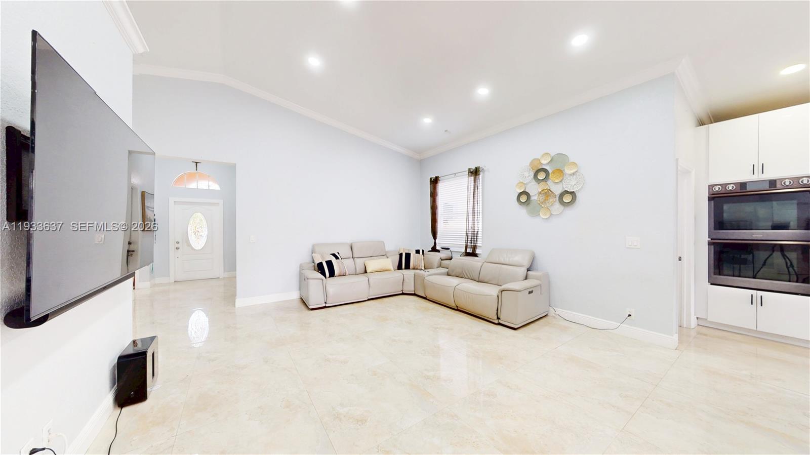13877 Southwest 50th Street Miramar, FL 33027 - Photo 12 of 54 a living room with furniture and a flat screen tv