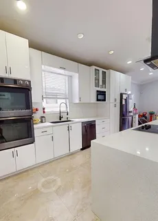 a kitchen with stainless steel appliances a microwave a sink and a stove