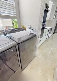 a kitchen with stainless steel appliances a microwave a sink and a stove