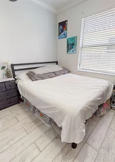 a bedroom with a bed and a window