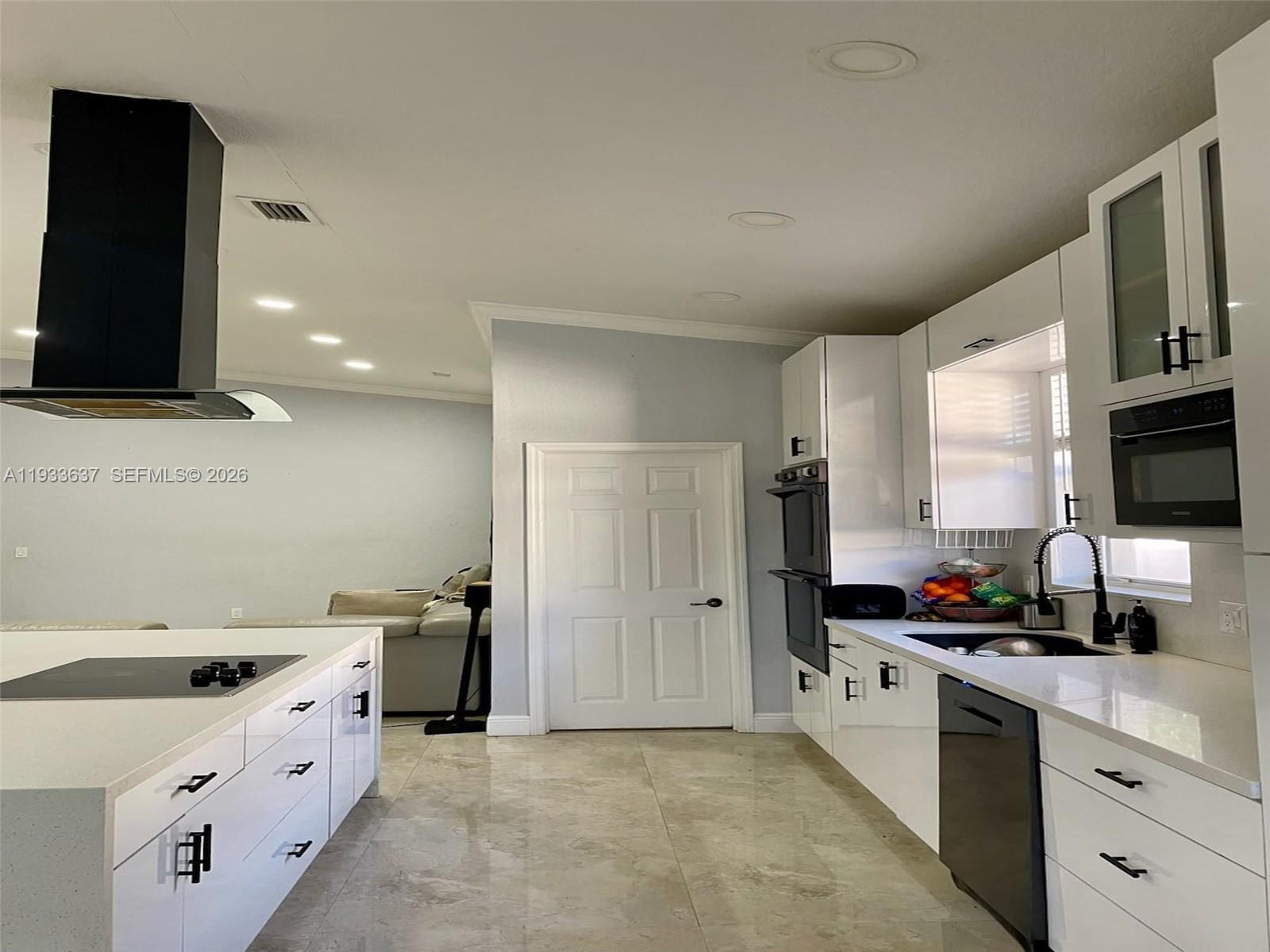 13877 Southwest 50th Street Miramar, FL 33027 - Photo 16 of 54 a kitchen with a sink stove and refrigerator