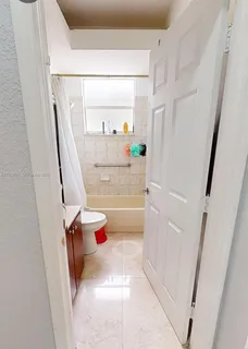 a view of a hallway with a dining table and chair