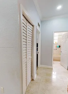a view of a hallway with a dining table and chair