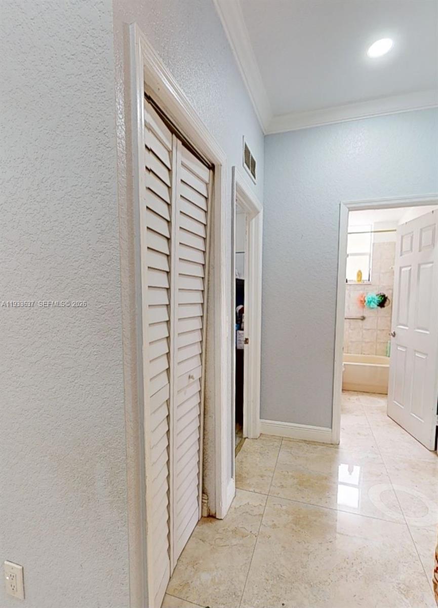 13877 Southwest 50th Street Miramar, FL 33027 - Photo 18 of 25 a view of a hallway with a dining table and chair