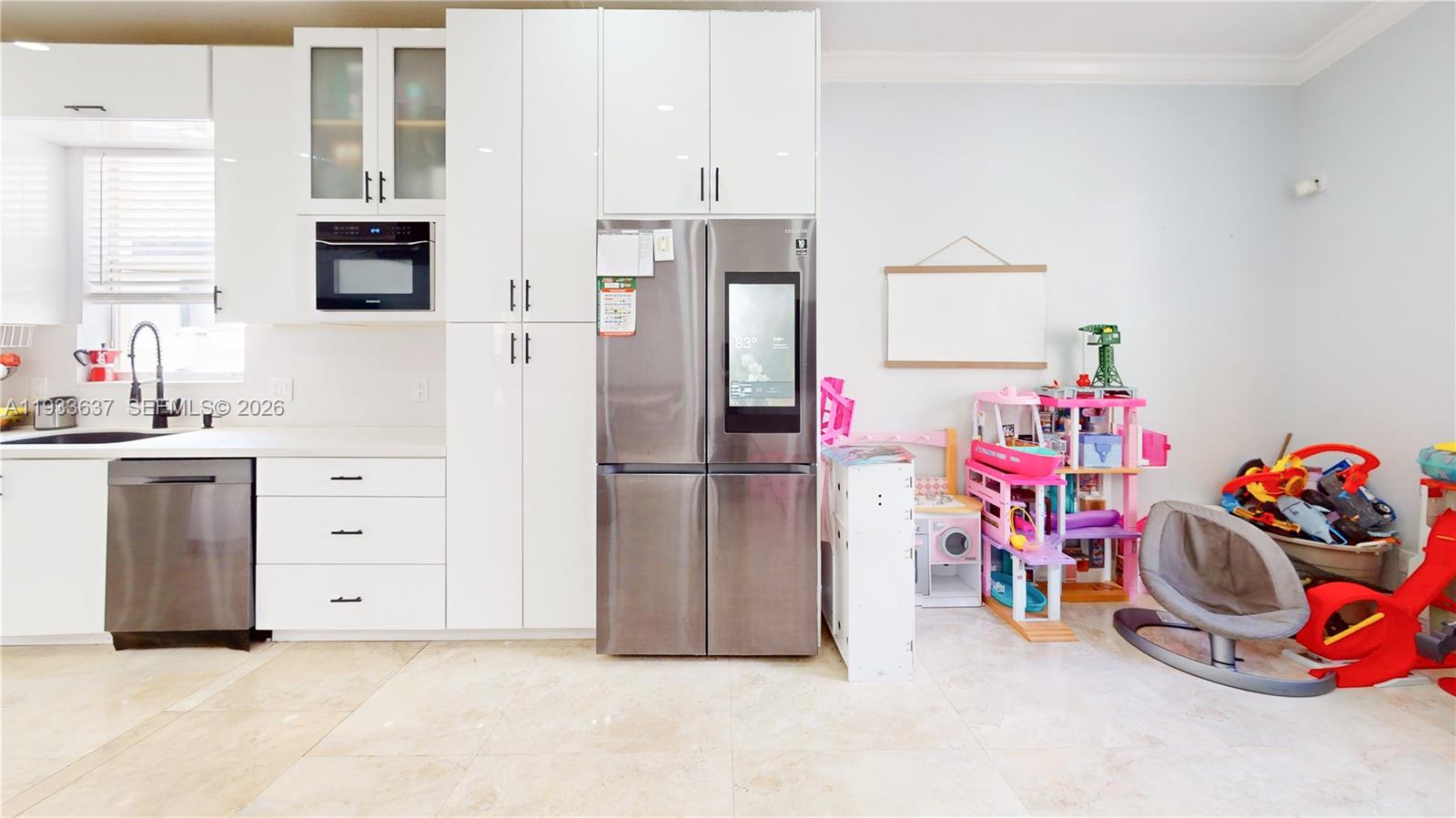 13877 Southwest 50th Street Miramar, FL 33027 - Photo 18 of 54 a view of a kitchen with fridge and workspace