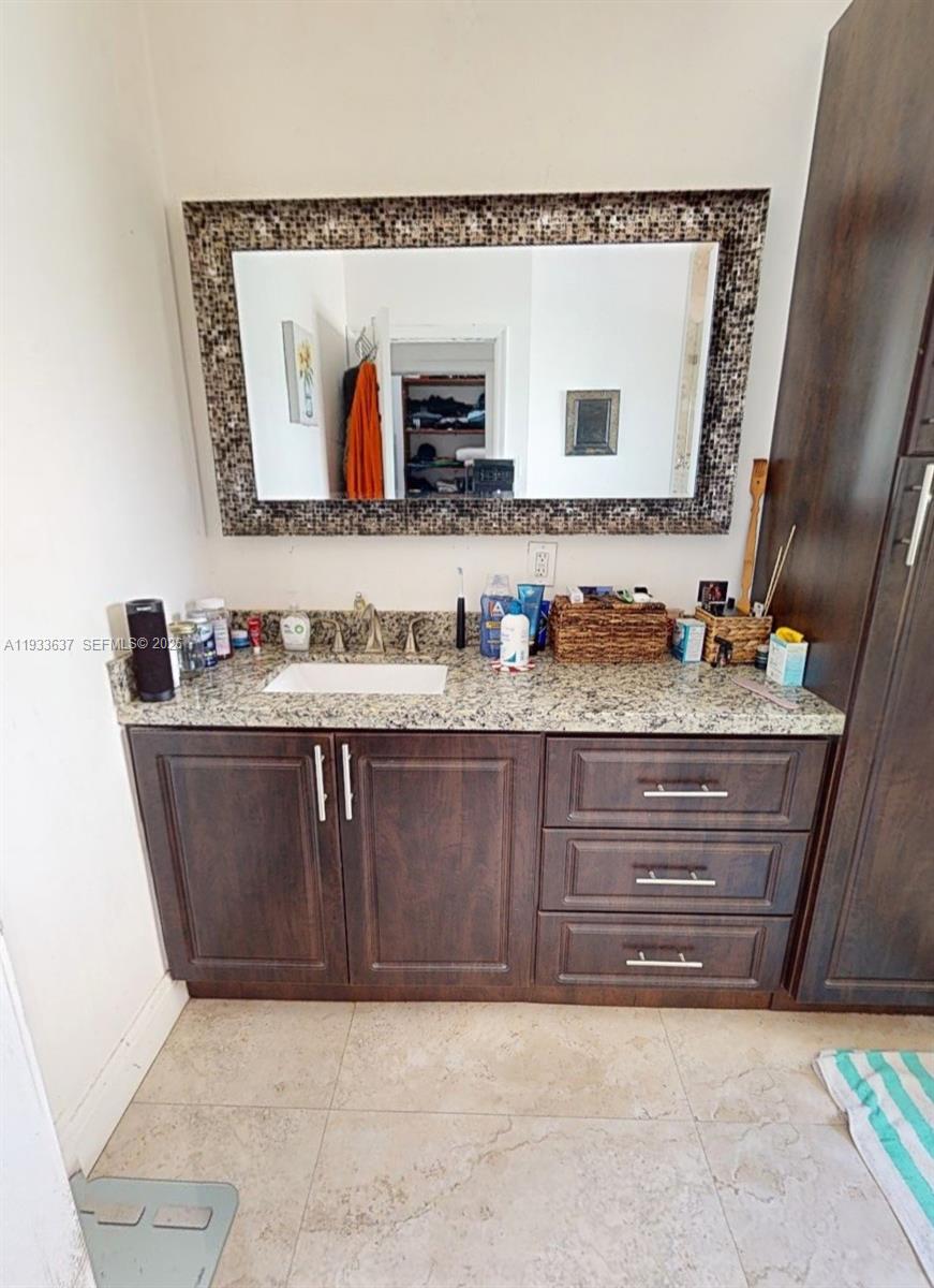 13877 Southwest 50th Street Miramar, FL 33027 - Photo 19 of 25 a bathroom with a sink vanity and mirror