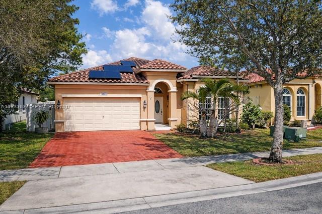 13877 Southwest 50th Street Miramar, FL 33027 - Photo 2 of 54 front view of a house with a yard