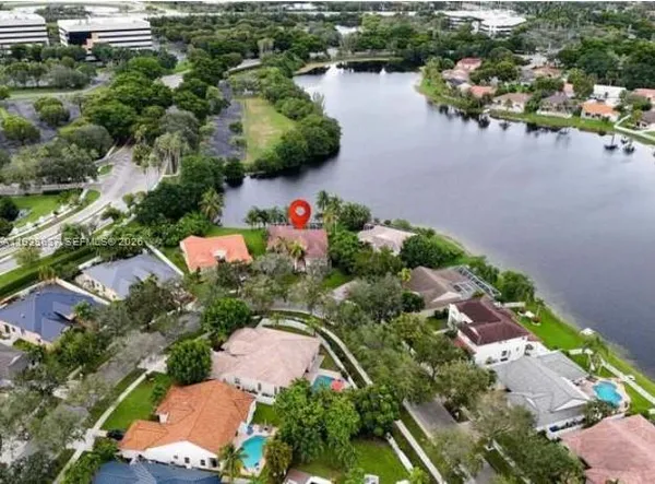 an aerial view of residential house with outdoor space and lake view