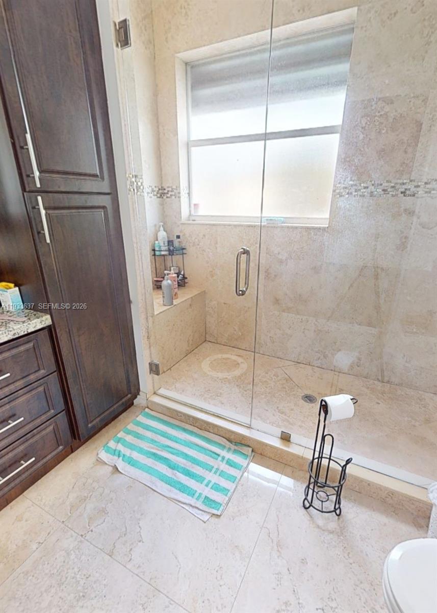13877 Southwest 50th Street Miramar, FL 33027 - Photo 21 of 25 a bathroom with a sink and a shower
