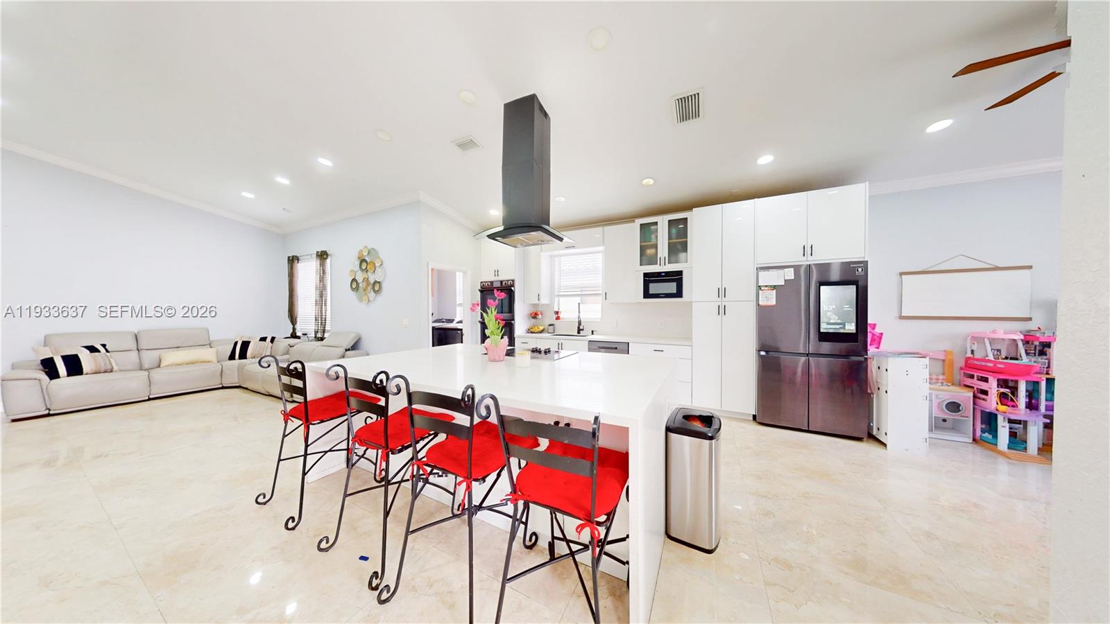 13877 Southwest 50th Street Miramar, FL 33027 - Photo 21 of 54 a living room with furniture and kitchen view