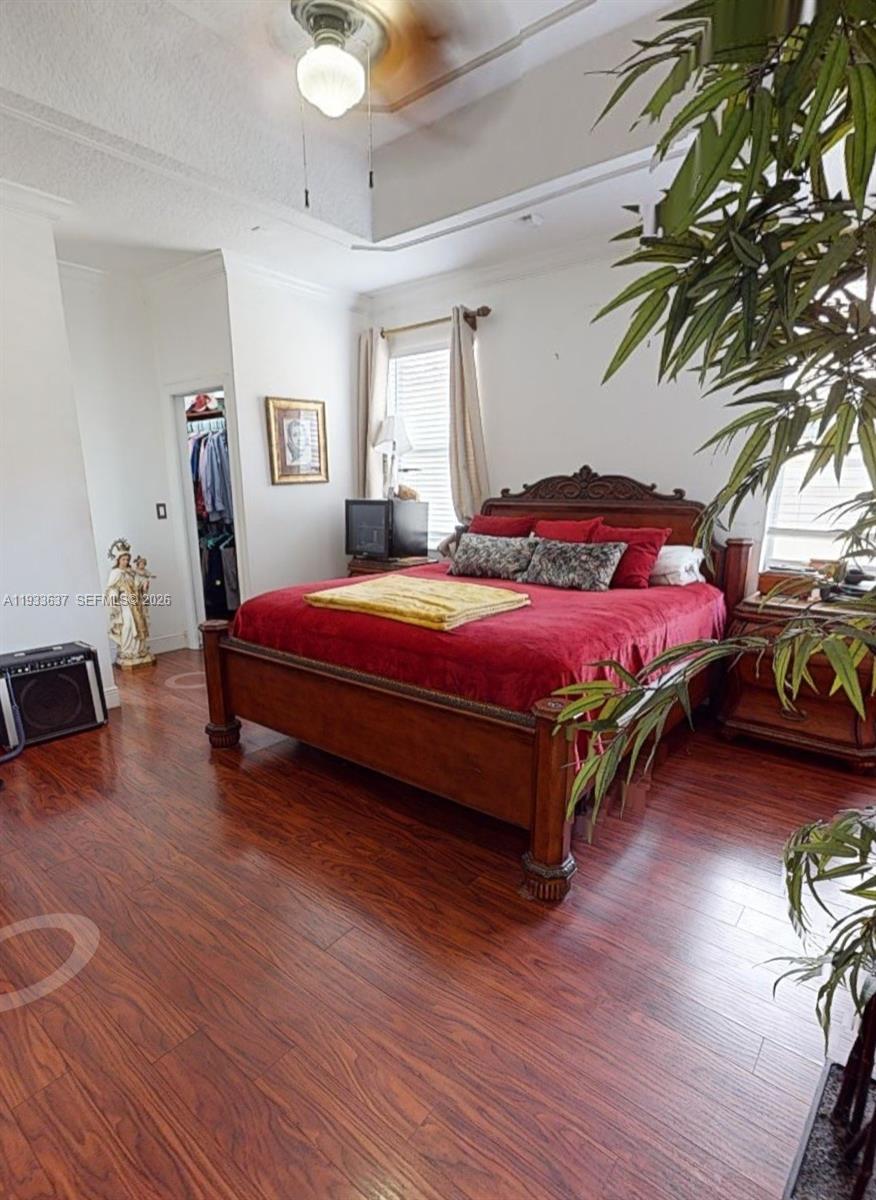 13877 Southwest 50th Street Miramar, FL 33027 - Photo 22 of 25 a bedroom with a bed and wooden floor