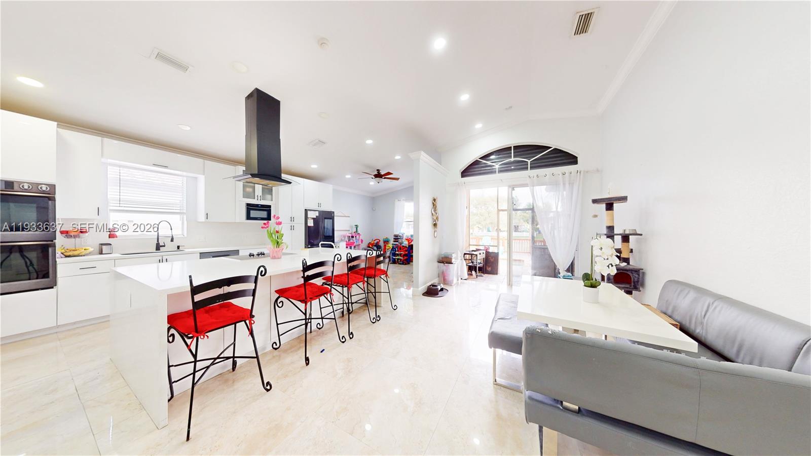 13877 Southwest 50th Street Miramar, FL 33027 - Photo 22 of 54 a living room with furniture and kitchen view