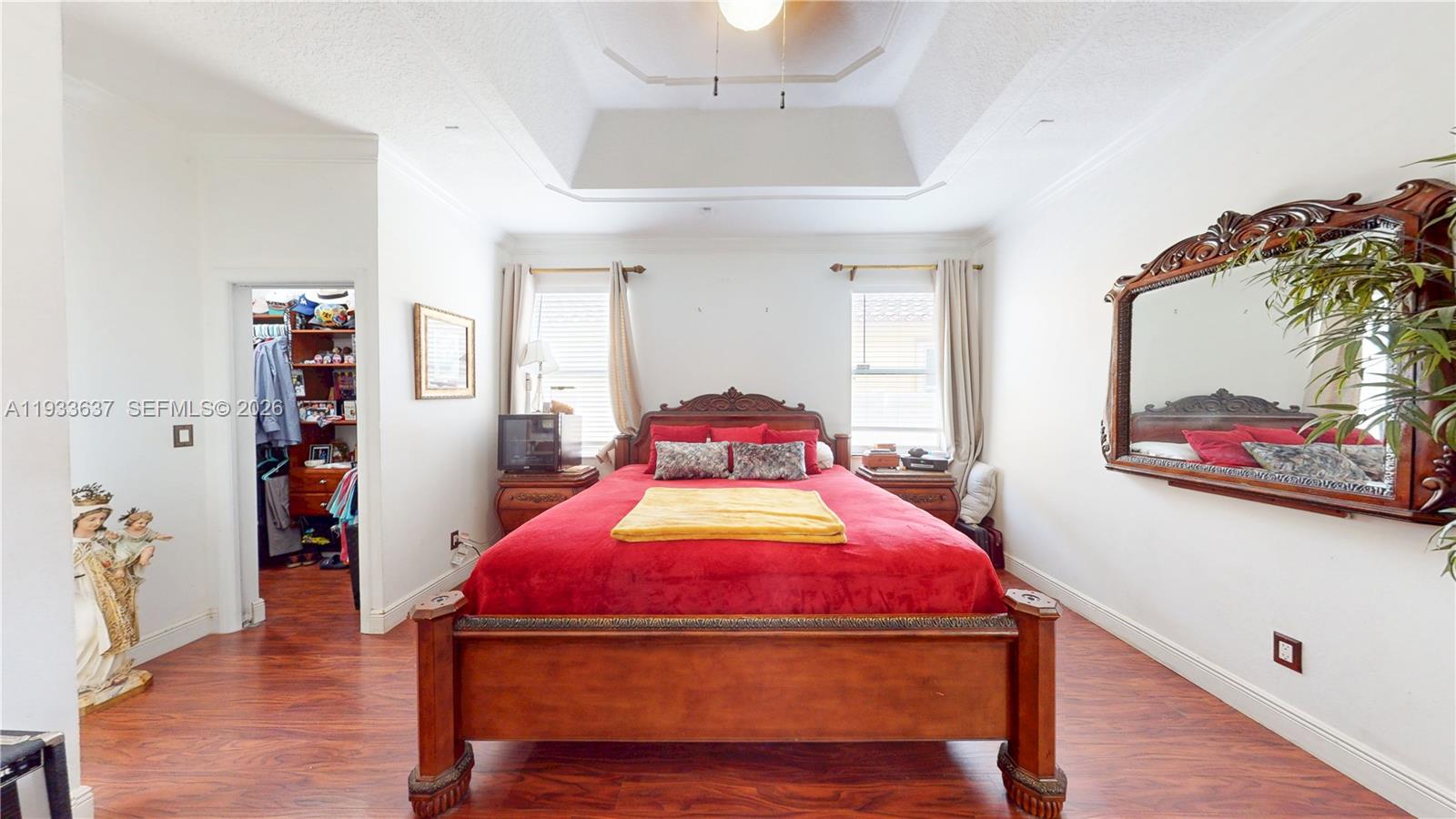 13877 Southwest 50th Street Miramar, FL 33027 - Photo 29 of 54 a bedroom with a bed and a chandelier