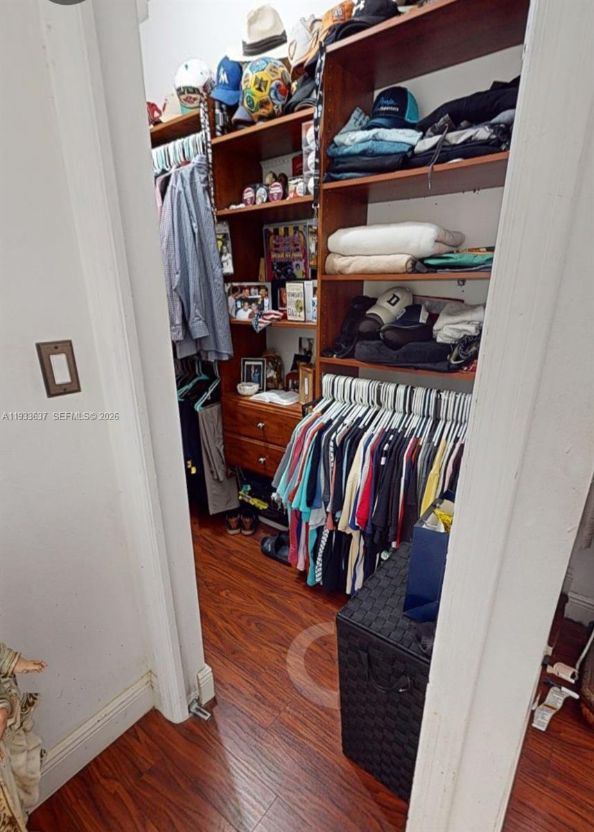 13877 Southwest 50th Street Miramar, FL 33027 - Photo 30 of 54 a view of walk in closet with clothes and shoes