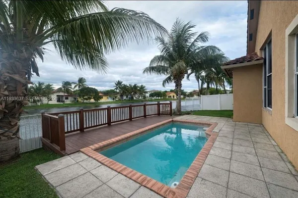 a view of a swimming pool with a table and chairs