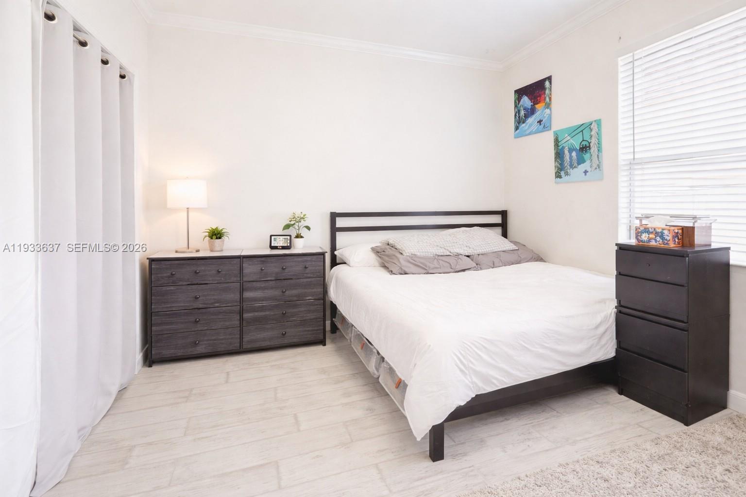 13877 Southwest 50th Street Miramar, FL 33027 - Photo 34 of 54 a bedroom with a bed and wooden floor