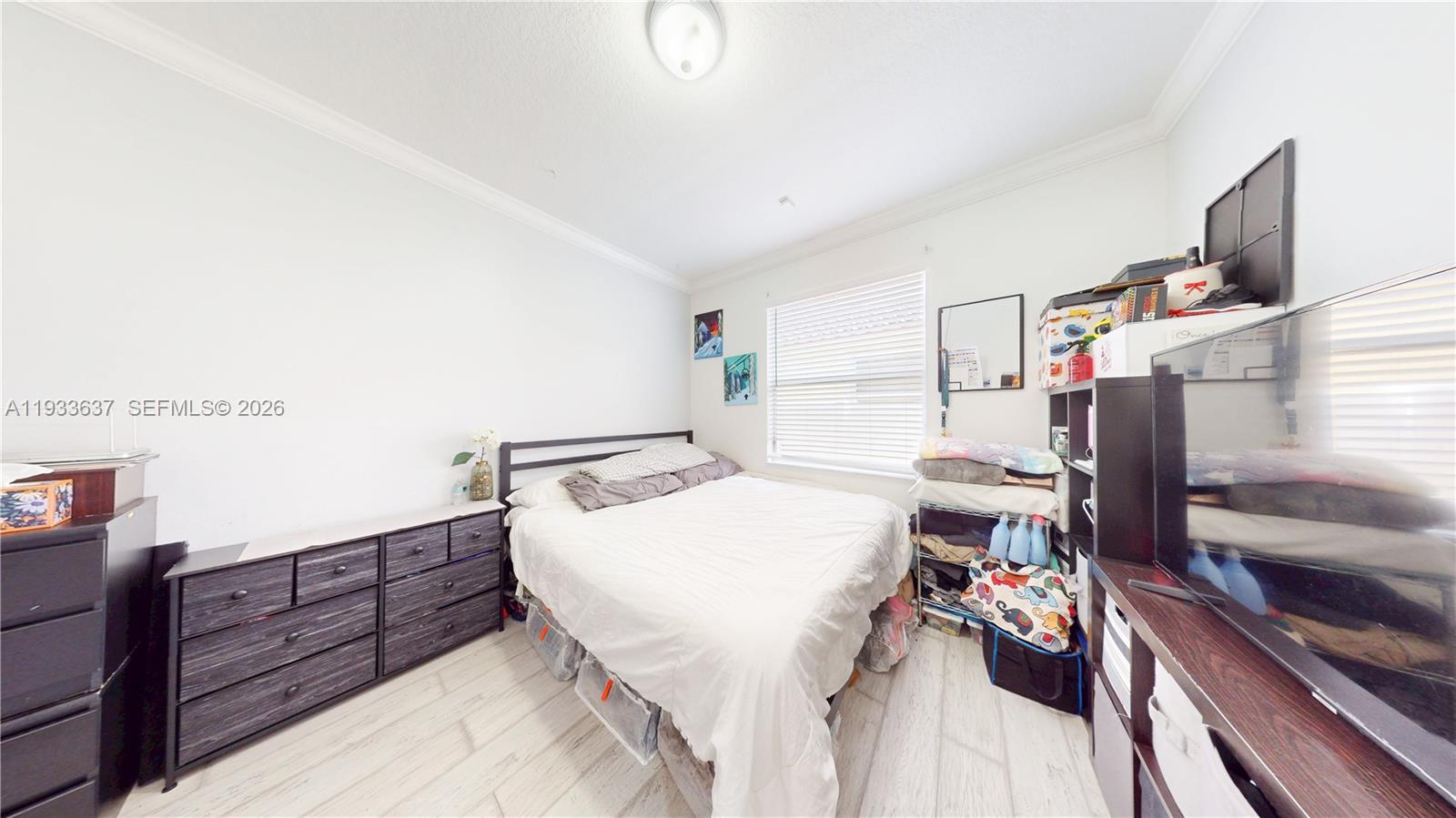 13877 Southwest 50th Street Miramar, FL 33027 - Photo 36 of 54 a living room with furniture and a flat screen tv