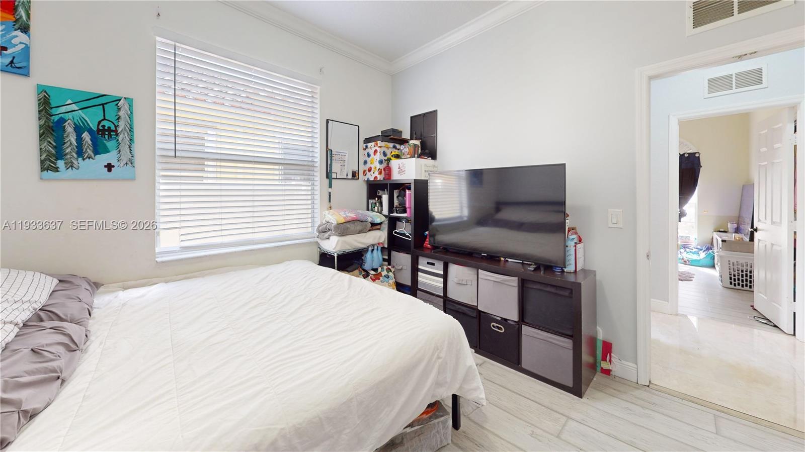 13877 Southwest 50th Street Miramar, FL 33027 - Photo 37 of 54 a bedroom with a bed and a large mirror on the dresser