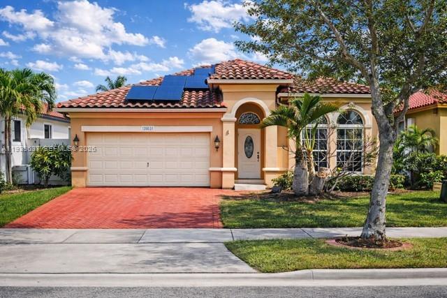13877 Southwest 50th Street Miramar, FL 33027 - Photo 4 of 54 a front view of a house with a yard