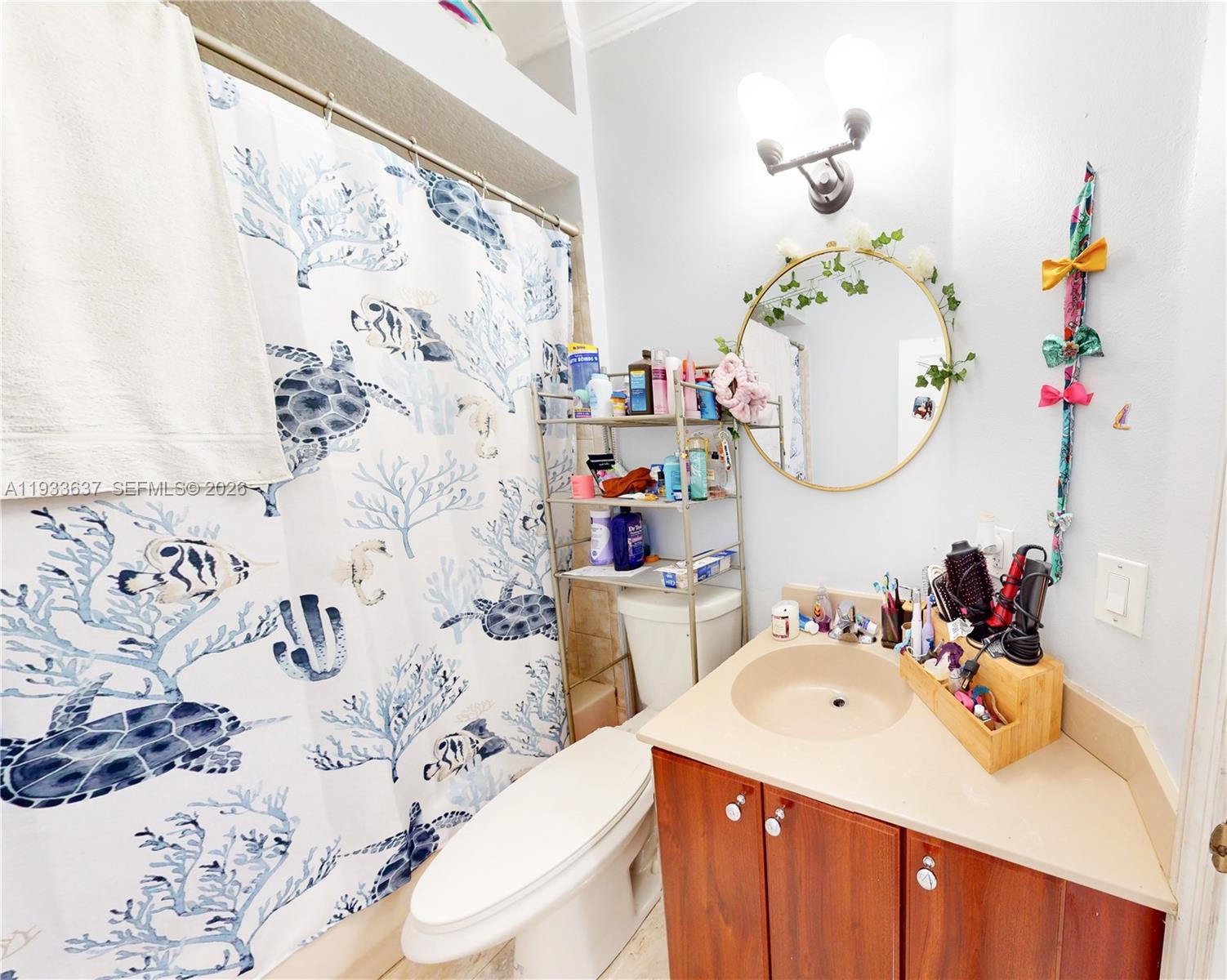 13877 Southwest 50th Street Miramar, FL 33027 - Photo 41 of 54 a bathroom with a sink vanity mirror bathtub and toilet