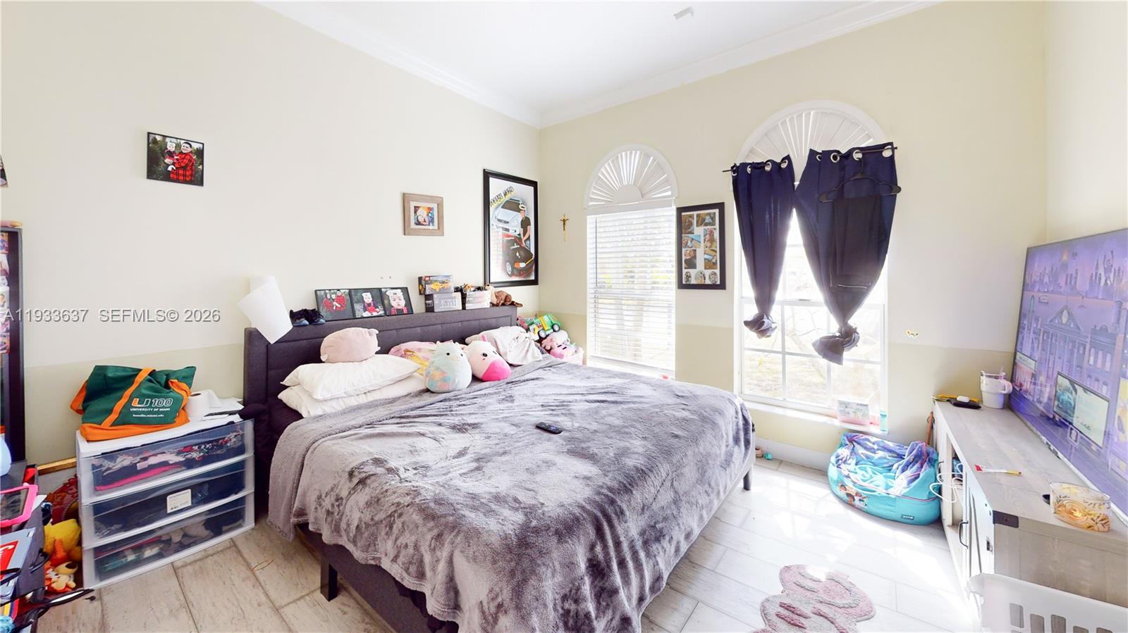 13877 Southwest 50th Street Miramar, FL 33027 - Photo 44 of 54 a bedroom with a bed a dresser and book shelf