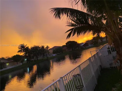 a kitchen with sink and view of living room