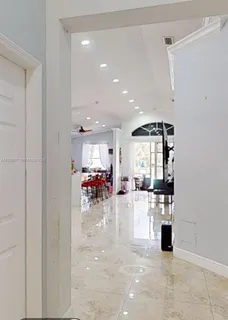 a kitchen with sink and view of living room