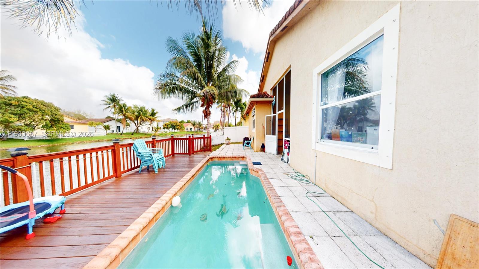 13877 Southwest 50th Street Miramar, FL 33027 - Photo 52 of 54 a view of a house with a swimming pool