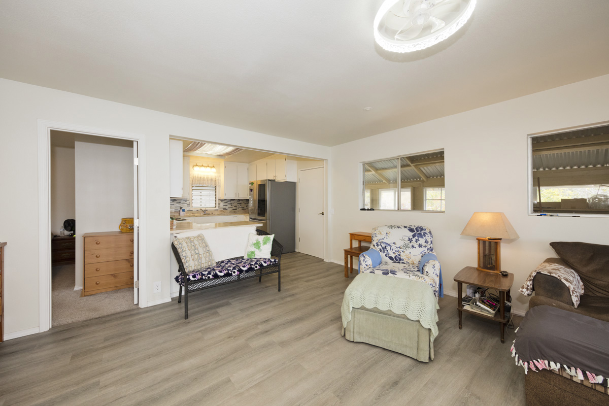 92-1663 Keaka Parkway Ocean View, HI 96704 - Photo 18 of 30 a bedroom with furniture and a large window