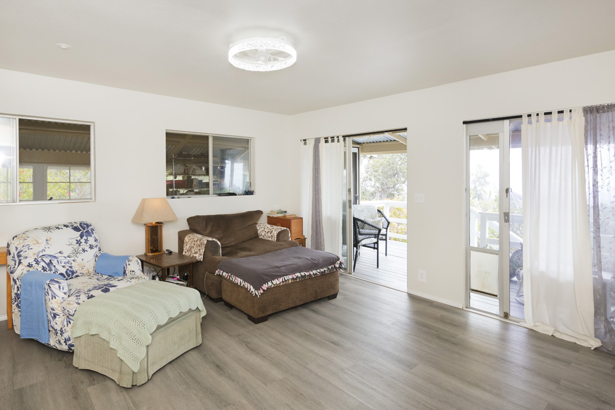 92-1663 Keaka Parkway Ocean View, HI 96704 - Photo 19 of 30 a bedroom with furniture and a window