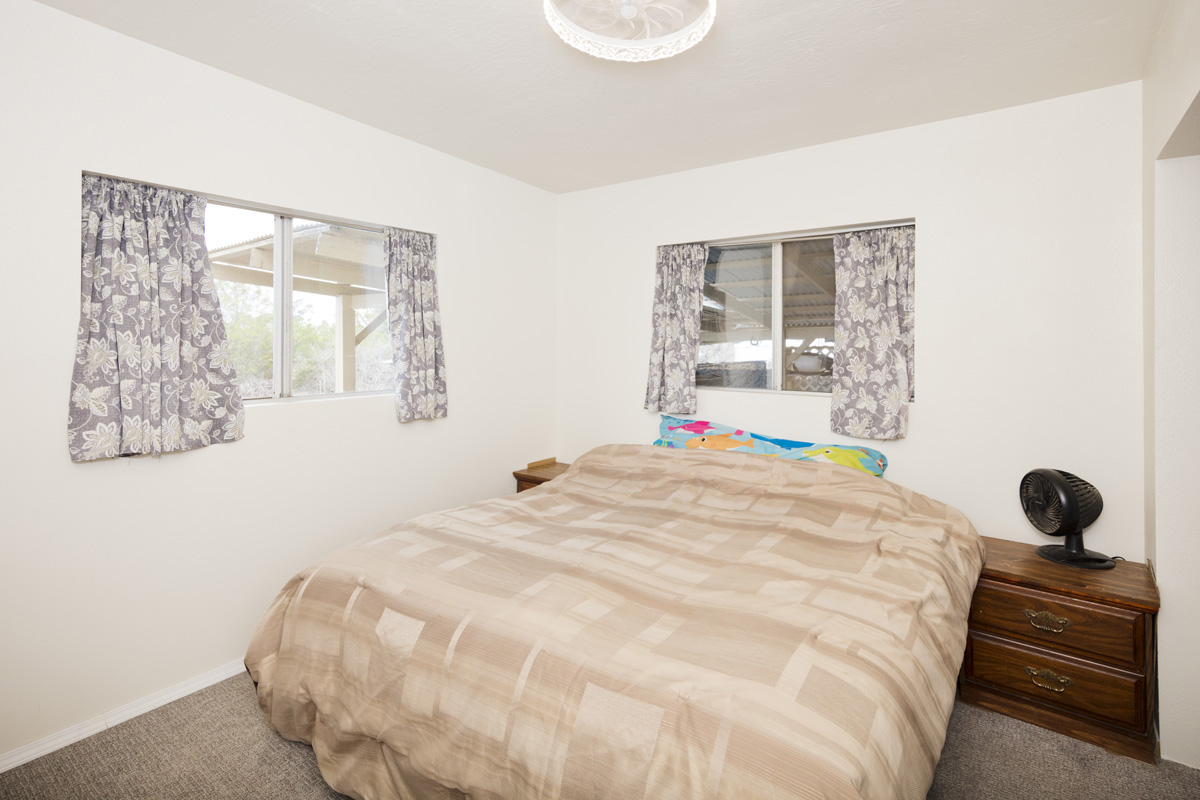 92-1663 Keaka Parkway Ocean View, HI 96704 - Photo 20 of 30 a bedroom with a bed and window