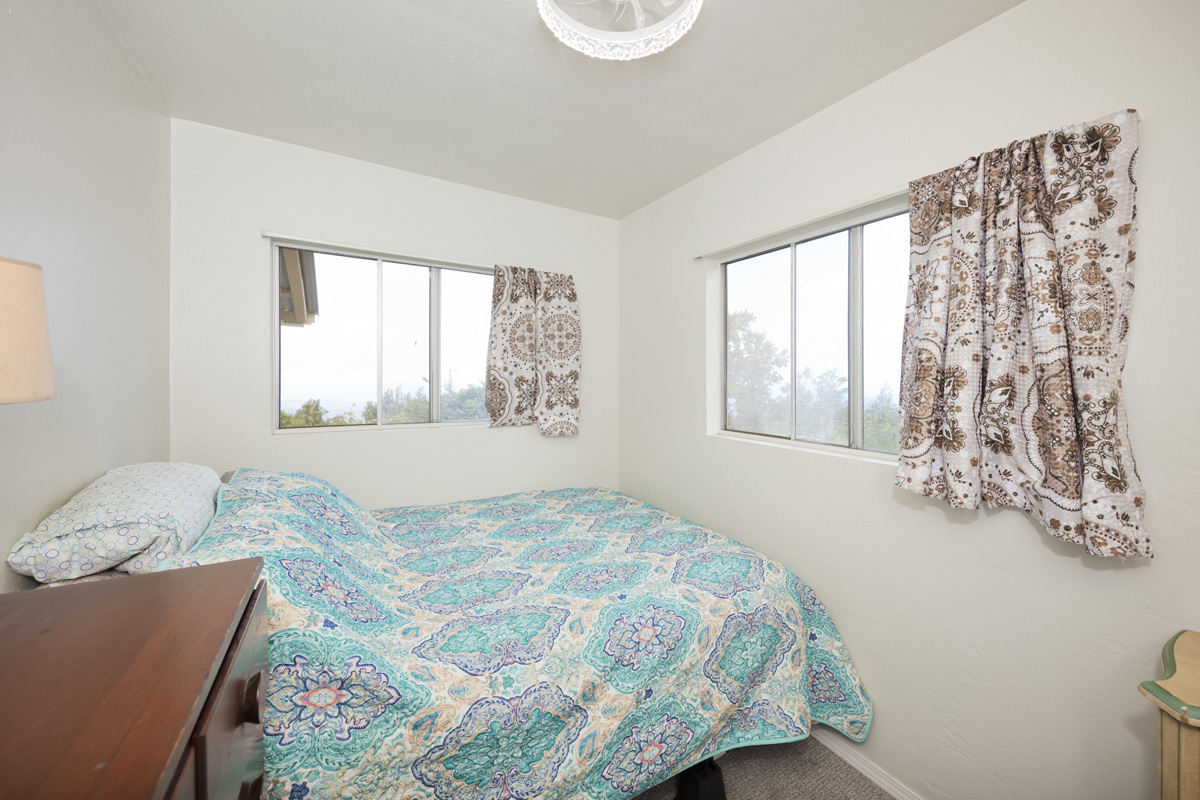 92-1663 Keaka Parkway Ocean View, HI 96704 - Photo 22 of 30 a bedroom with a bed and a window