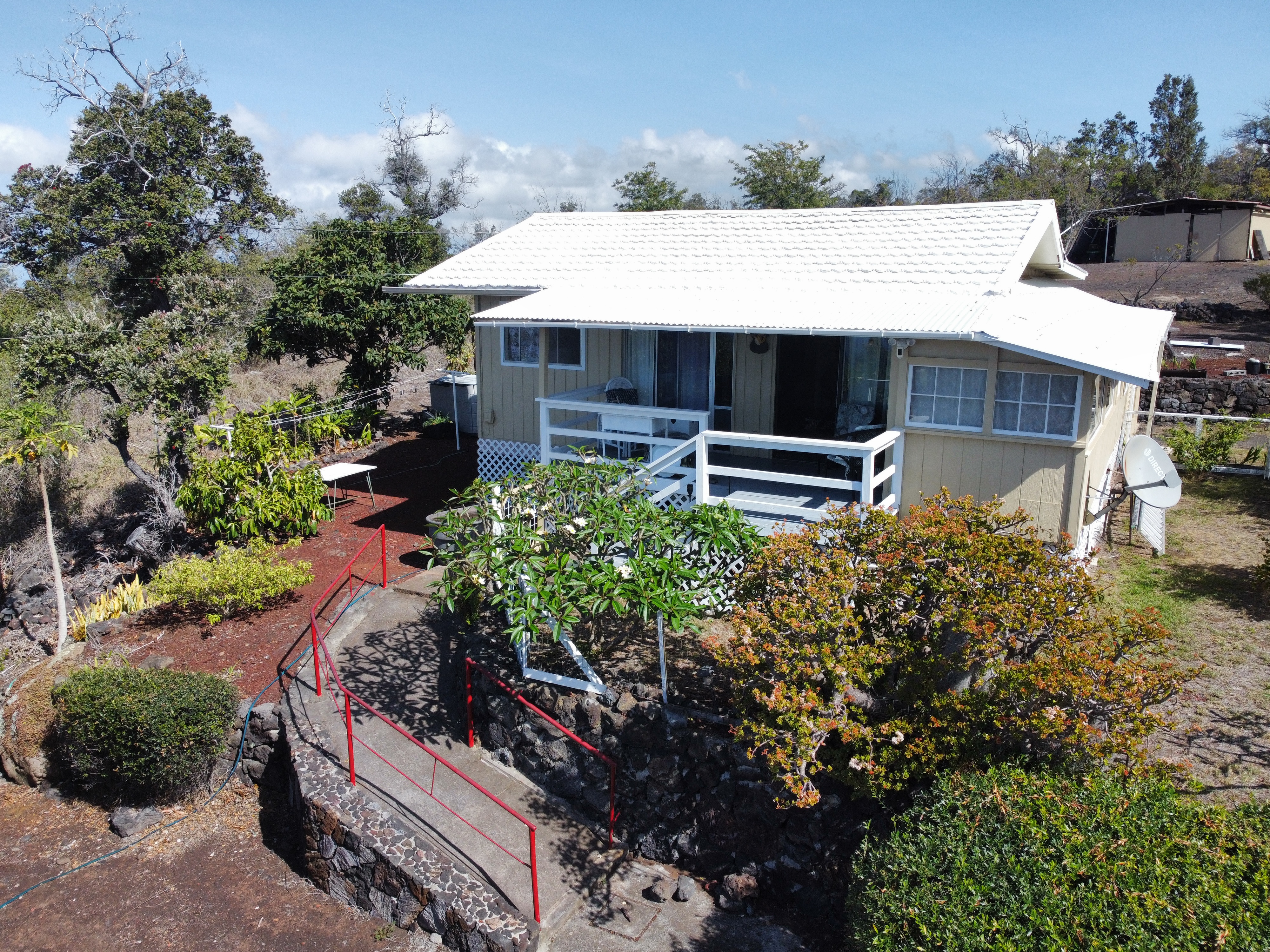 92-1663 Keaka Parkway Ocean View, HI 96704 - Photo 7 of 30 a view of a house with a yard and sitting area