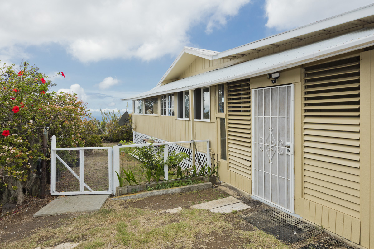 92-1663 Keaka Parkway Ocean View, HI 96704 - Photo 8 of 30 a front view of a house with a yard