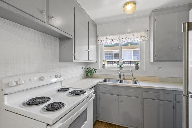 2056 Trinity Street San Mateo, CA 94403 - Photo 11 of 42 a kitchen with a sink a stove and cabinets