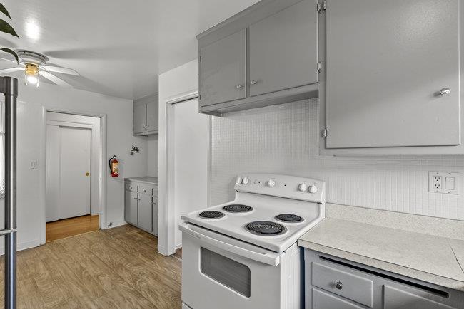 2056 Trinity Street San Mateo, CA 94403 - Photo 12 of 42 a kitchen with a stove and a refrigerator