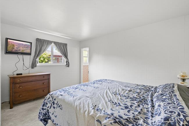 2056 Trinity Street San Mateo, CA 94403 - Photo 17 of 42 a bedroom with a bed and dresser with mirror