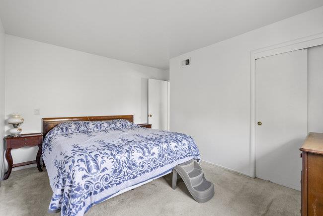 2056 Trinity Street San Mateo, CA 94403 - Photo 18 of 42 a bed sitting in a bedroom next to a bathroom