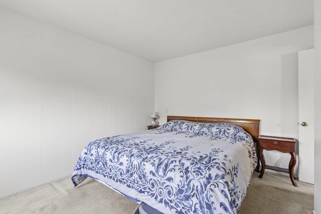 2056 Trinity Street San Mateo, CA 94403 - Photo 19 of 42 a bedroom with a bed and a chair