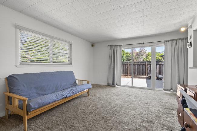 2056 Trinity Street San Mateo, CA 94403 - Photo 25 of 42 a living room with furniture and a floor to ceiling window