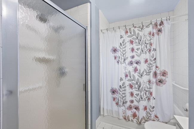 2056 Trinity Street San Mateo, CA 94403 - Photo 29 of 42 a bathroom with a shower curtain and a toilet