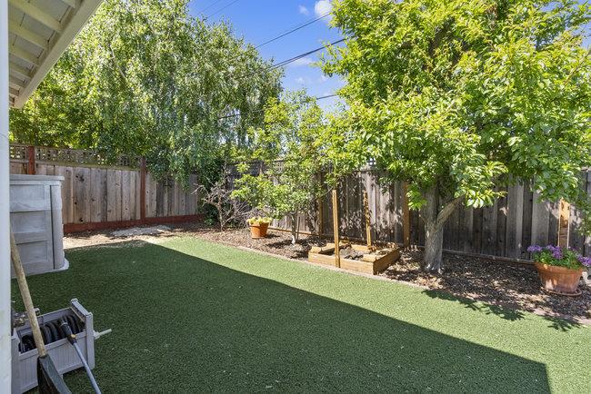 2056 Trinity Street San Mateo, CA 94403 - Photo 34 of 42 a backyard of a house with table and chairs a barbeque and wooden fence