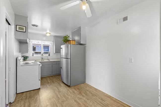 2056 Trinity Street San Mateo, CA 94403 - Photo 10 of 42 a kitchen with a refrigerator a washer and dryer