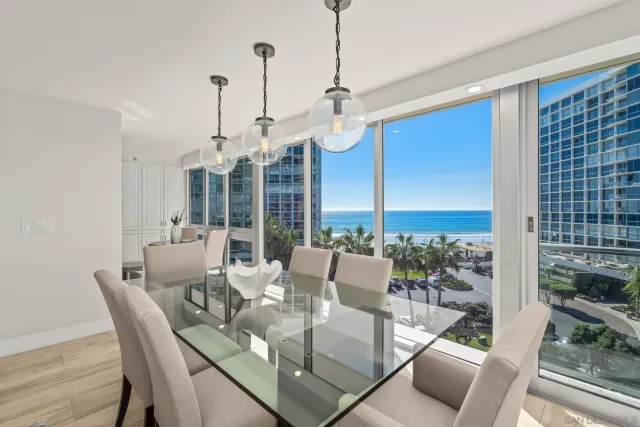 a dining room with furniture a chandelier and wooden floor