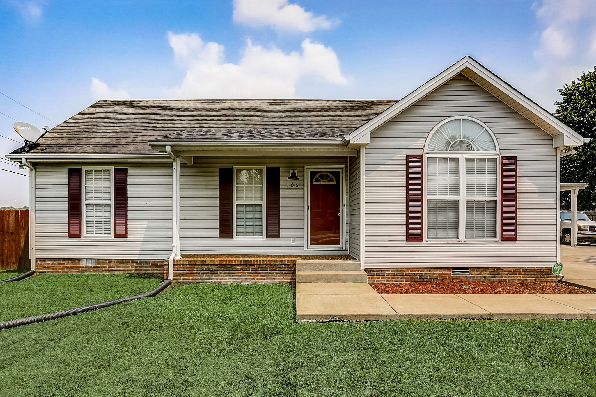a front view of a house with a yard